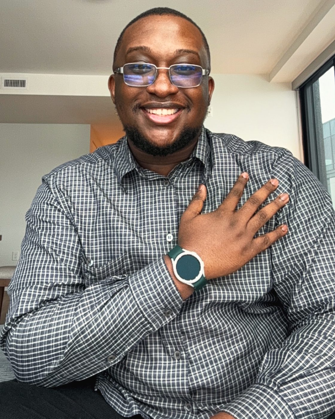 Portrait of Joshua smiling, hand on chest