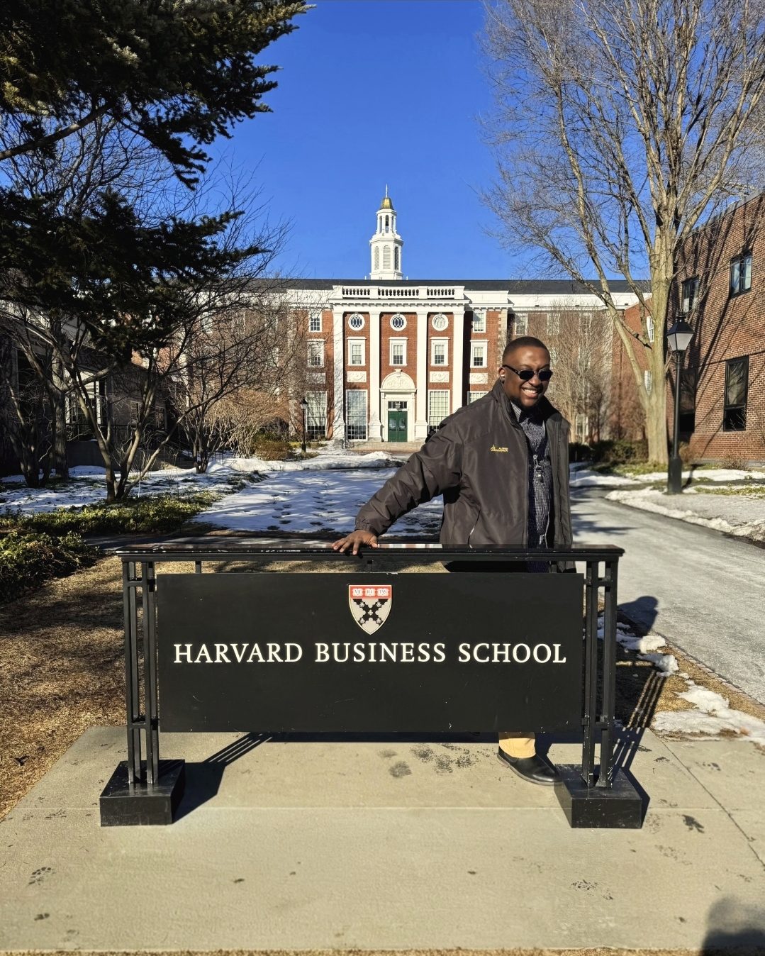 Joshua at the Harvard Business School sign